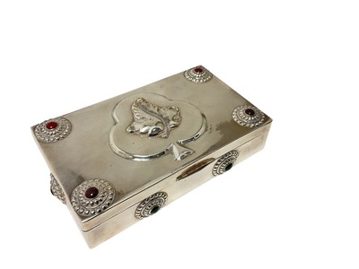 Lot 139 - Italian silver plated cigarette box of rectangular form, with hinged cover, decorated with a leaf motif and hardstone centred roundels, retailer's label to base (unmarked). 15.2cm across.