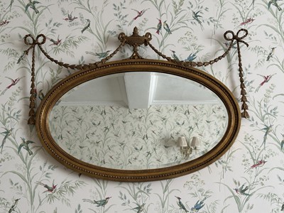 Lot 1332 - Victorian gilt oval wall mirror with urn and harebell swags, 93cm wide x 64cm high