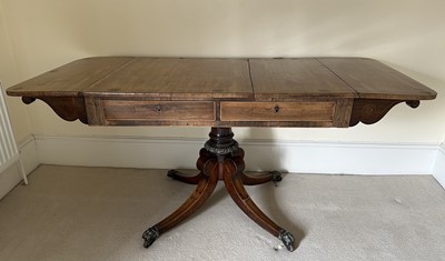 Lot 1356 - Regency rosewood sofa table, inlaid with stringing and brass circular medallions, the top with hinged sides