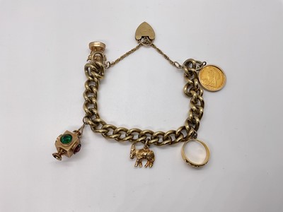 Lot 50 - 9ct gold charm bracelet with a collection of gold charms to include a Victorian gold half sovereign