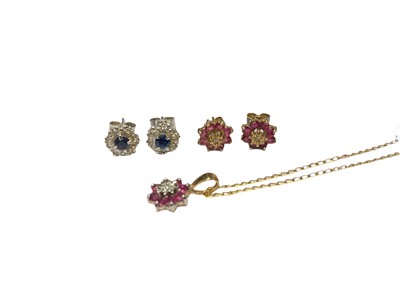 Lot 210 - Pair of sapphire and diamond cluster earrings in white gold setting, a pair of ruby and diamond cluster earrings and matching pendant in gold mount on chain