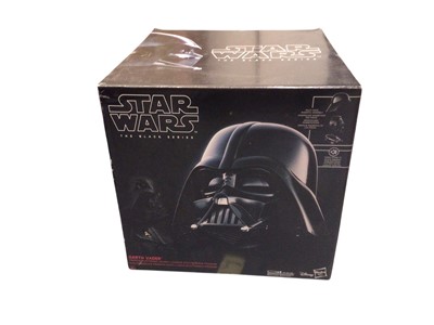 Lot 354 - Hasbro The Black Series Helmets Darth Vader & Boda Fett, both boxed, plus one other loose Darth Vader Helmet (3)