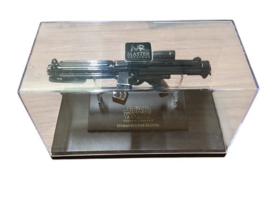 Lot 15 - Star Wars Master Replica Episode IV: A New Hope small scaled Stormtrooper Blaster & Episode V:The Empire Strikes Back Han Solo Blaster, both in display cases