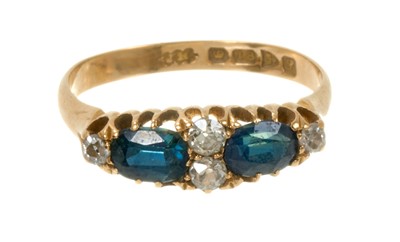 Lot 606 - Edwardian sapphire and diamond ring with two oval mixed cut blue sapphires and four old cut diamonds in 18ct gold setting