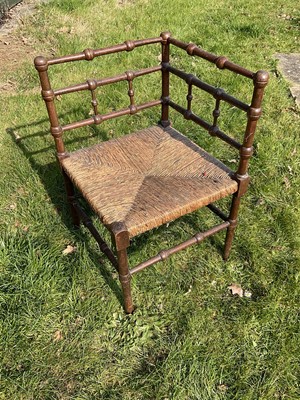 Lot 1454 - Arts and crafts oak corner chain in the manner of Liberty's with caned seat and turned lattice back