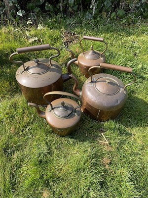 Lot 1456 - Two 19th century oversized copper kettles, the largest 38cm high and two others smaller. (4)