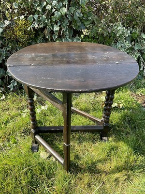 Lot 1464 - 17th century oak narrow drop leaf table, the elliptical hinged top on bobbin turned supports and sledge base, 76 x 76cm