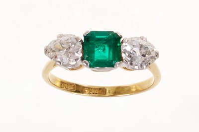 Lot 548 - Emerald and diamond three stone ring with a square step cut emerald flanked by two old cut pear-shaped diamonds in platinum claw setting on 18ct gold shank