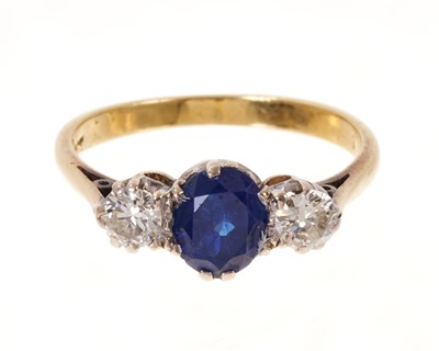 Lot 550 - Sapphire and diamond three stone ring with a round mixed cut blue sapphire flanked by two brilliant cut diamonds in claw setting on 18ct gold shank