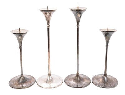 Lot 292 - Set of four Arts & Crafts silver candlesticks