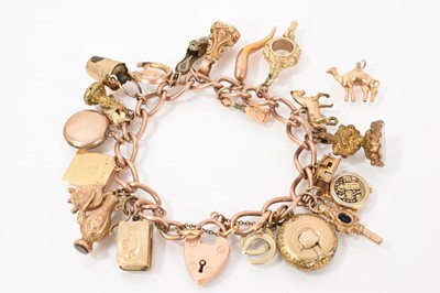 Lot 598 - Edwardian 9ct rose gold curb link charm bracelet with various antique and later gold and yellow charms