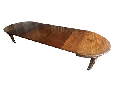 Lot 1493 - An impressive Victorian mahogany extending dining table, the D-ends opening to take four further leaves, on turned, tapered and fluted legs terminating on brass capped castors, 358cm long extend...