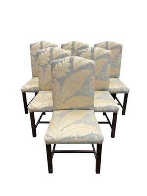 Lot 1494 - Set of twelve upholstered dining chairs with arched backs, foliate leaf pattern fabric, on square legs joined by stretchers