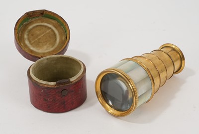 Lot 765 - An early 19th century French Palais Royal four draw eye glass, mounted with mother of pearl panels, in original velvet lined leather case, 10.5cm when extended, case 5cm high x 6.5cm diameter