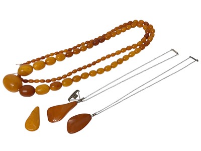 Lot 642 - Vintage amber bead necklace together with three other amber pendants