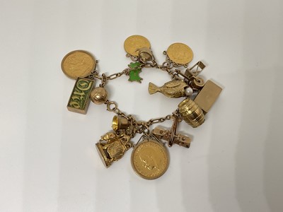 Lot 57 - 9ct gold charm bracelet with a collection of gold charms to include a two gold full sovereigns, two gold half sovereigns