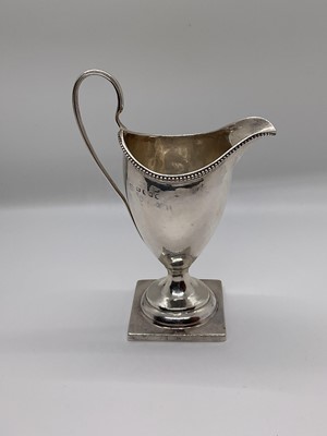 Lot 45 - George III silver helmet shaped cream jug, on square base