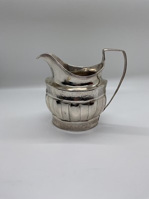Lot 44 - George III silver helmet shaped cream jug with reeded, engraved and fluted borders