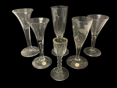 Lot 57 - Six Georgian drinking glasses, including two with teared stems and folded feet, one plain stem with drawn trumpet bowl, one etched with vines and wheat, an ale flute with faceted stem and a cord...