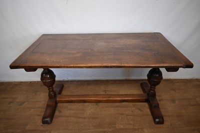 Lot 1379 - 17th century style oak refectory table, the plank top with cleated ends, on cup and cover supports and sledge bases, 151cm long x 84cm deep x 82cm high