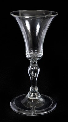 Lot 62 - Baluster wine glass, circa 1730-40, with a bell shaped bowl, on a stem with teared inverted baluster and basal knops, folded foot, 14.75cm high