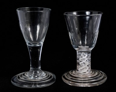 Lot 66 - 18th century firing glass, with fluted round funnel bowl, double series opaque twist stem, and stepped foot, together with another firing glass with fluted bowl and stepped foot, 10cm and 10....