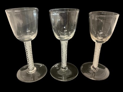 Lot 21 - Three 18th century double series opaque twist wine glasses, with round funnel bowls, plain stems and feet, 14.5cm to 15.25cm high
