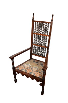 Lot 1434 - Arts and Crafts Moorish oak armchair by Liberty & Co, with lattice back and slip in seat on turned legs, Liberty & Co. label to underside