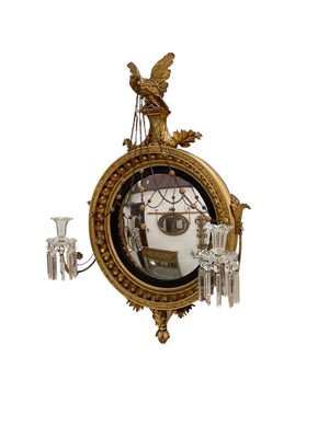 Lot 1447 - Regency gilt convex girandole, with eagle surmount, the circular plate in ebonised slip and ball moulded concave frame with flanking candle arms issuing prismatic drops, 93 x 66cm
