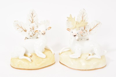 Lot 123 - Pair of Samuel Alcock porcelain figures of a doe and stag, circa 1830, sparsely decorated, shown seated on gilt-lined bases, 11.5cm high