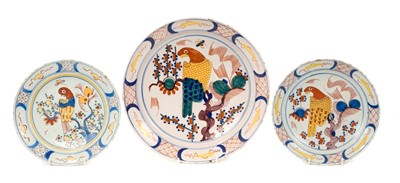 Lot 5 - Trio of 18th century Dutch delftware plates, polychrome painted in the Chinese style with parrots, the smaller two measuring 22cm and 22.5cm diameter, the larger measuring 30.5cm