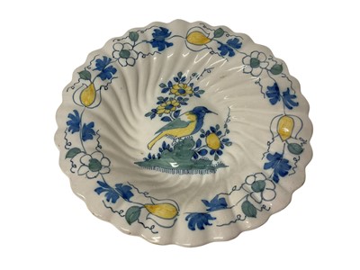 Lot 128 - 18th century lobed Delft dish, polychrome painted with a bird, the outside with foliage, 29.5cm diameter