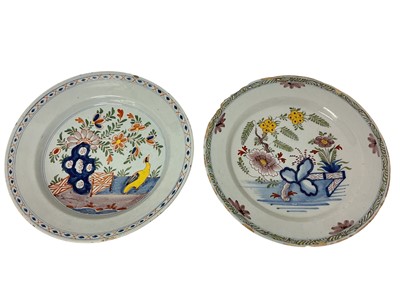Lot 130 - Two 18th century Delft dishes, polychrome painted in the Chinese style with fence patterns, one with a bird, 35cm and 34.5cm diameter