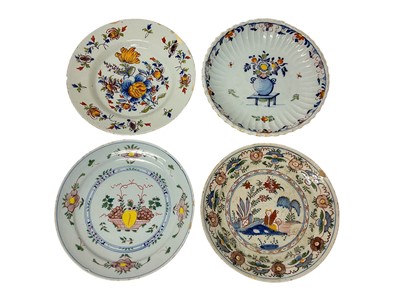 Lot 131 - Four 18th century Delft plates, including one with a Chinese figure in a garden, 22cm to 23cm diameter (4)