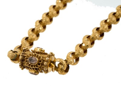 Lot 520 - Regency yellow metal chain with large belcher links decorated with stars, the barrel clasp with cannetille work decoration and oval mixed cut pink stones