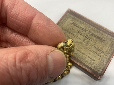 Lot 520 - Regency yellow metal chain with large belcher links decorated with stars, the barrel clasp with cannetille work decoration and oval mixed cut pink stones