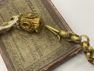 Lot 520 - Regency yellow metal chain with large belcher links decorated with stars, the barrel clasp with cannetille work decoration and oval mixed cut pink stones