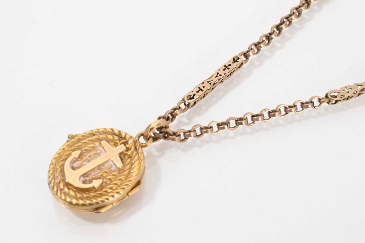 Lot 528 - Victorian gold oval locket with rope twist decoration and applied anchor, on yellow metal fancy link chain