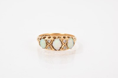 Lot 531 - Opal and diamond ring with three opal cabochons interspaced by four old cut diamonds in carved gold claw setting on 18ct gold shank, (Birmingham 1918)