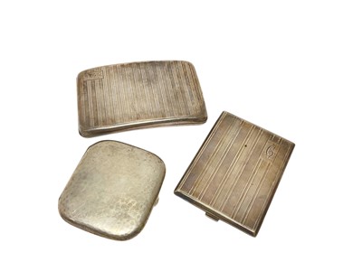 Lot 103 - George V silver cigarette case of rectangular form, with engine turned decoration, (Birmingham 1921), together with another silver cigarette case, (Birmingham 1927 ), and a German silver (800) (3).
