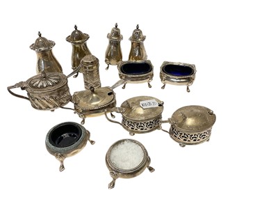 Lot 228 - Collection of thirteen silver pepperettes, salt cellars and mustard pots, (various dates and makers), approximately 14ozs of weighable silver.