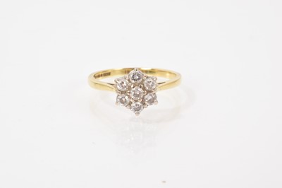 Lot 620 - 18ct gold diamond flower head cluster ring