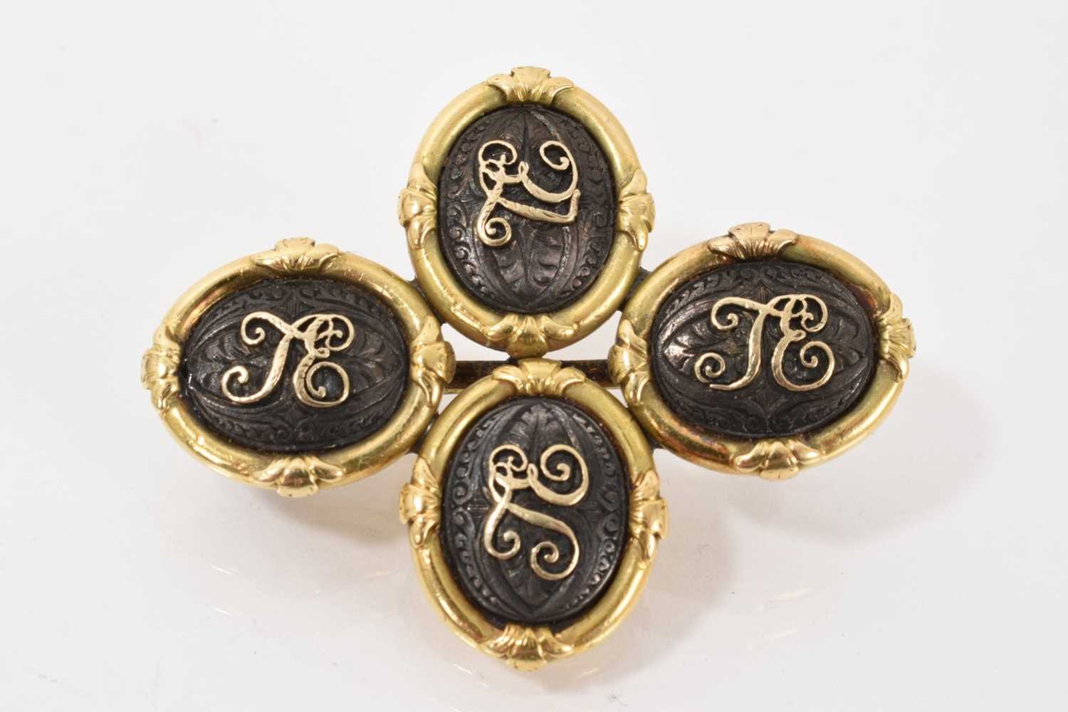 Lot 545 - Pair of 19th century gold and steel cufflinks later converted to a brooch, each oval plaque applied with gold initials on engraved steel ground, in yellow metal setting, 44mm x 35mm