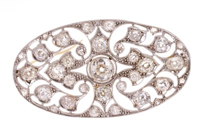 Lot 560 - Edwardian Belle Époque diamond plaque brooch, the pierced oval panel with old cut diamonds in millegrain setting