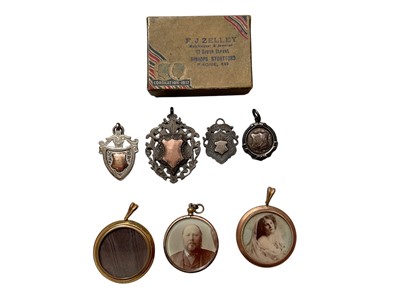 Lot 1133 - Four presentation silver fobs together with three antique rolled gold lockets with pictures inside