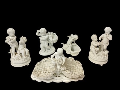 Lot 19 - Group of 19th century white glazed porcelain, including a figural double basket with crossed swords and 'DP' marks, a pair of putti groups, and two other putti sweetmeats (5)