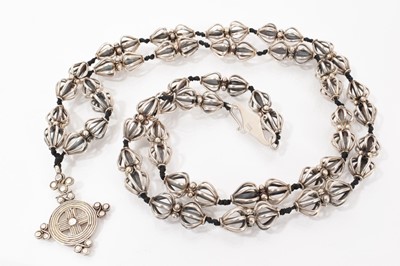 Lot 572 - Liberty Amuleti silver Celtic cross pendant necklace with silver open baluster shaped beads on black cord