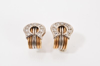 Lot 577 - Pair of yellow and white gold diamond set buckle ear clips