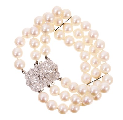 Lot 578 - Cultured pearl three strand bracelet with a white gold diamond set clasp