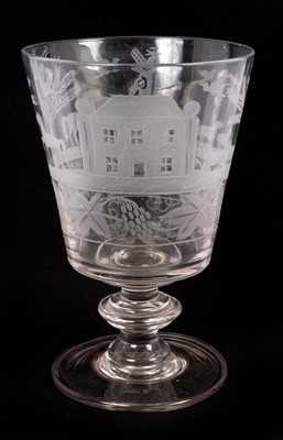 Lot 172 - A large early 19th century English glass goblet engraved with a country house, windmill and animals, with a border of grapevines below, 20.25cm high